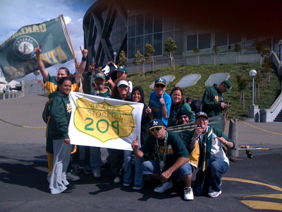 Left field bleacher fans with 209 banner